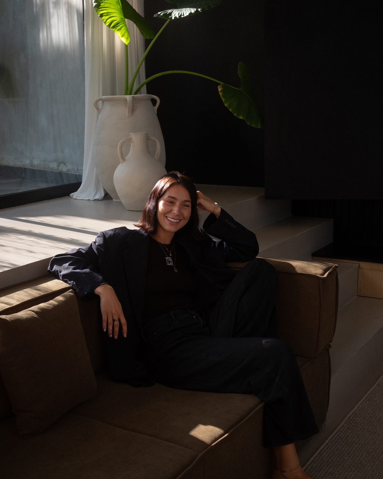 Becks, online yoga and Pilates coach, sitting in warm afternoon light