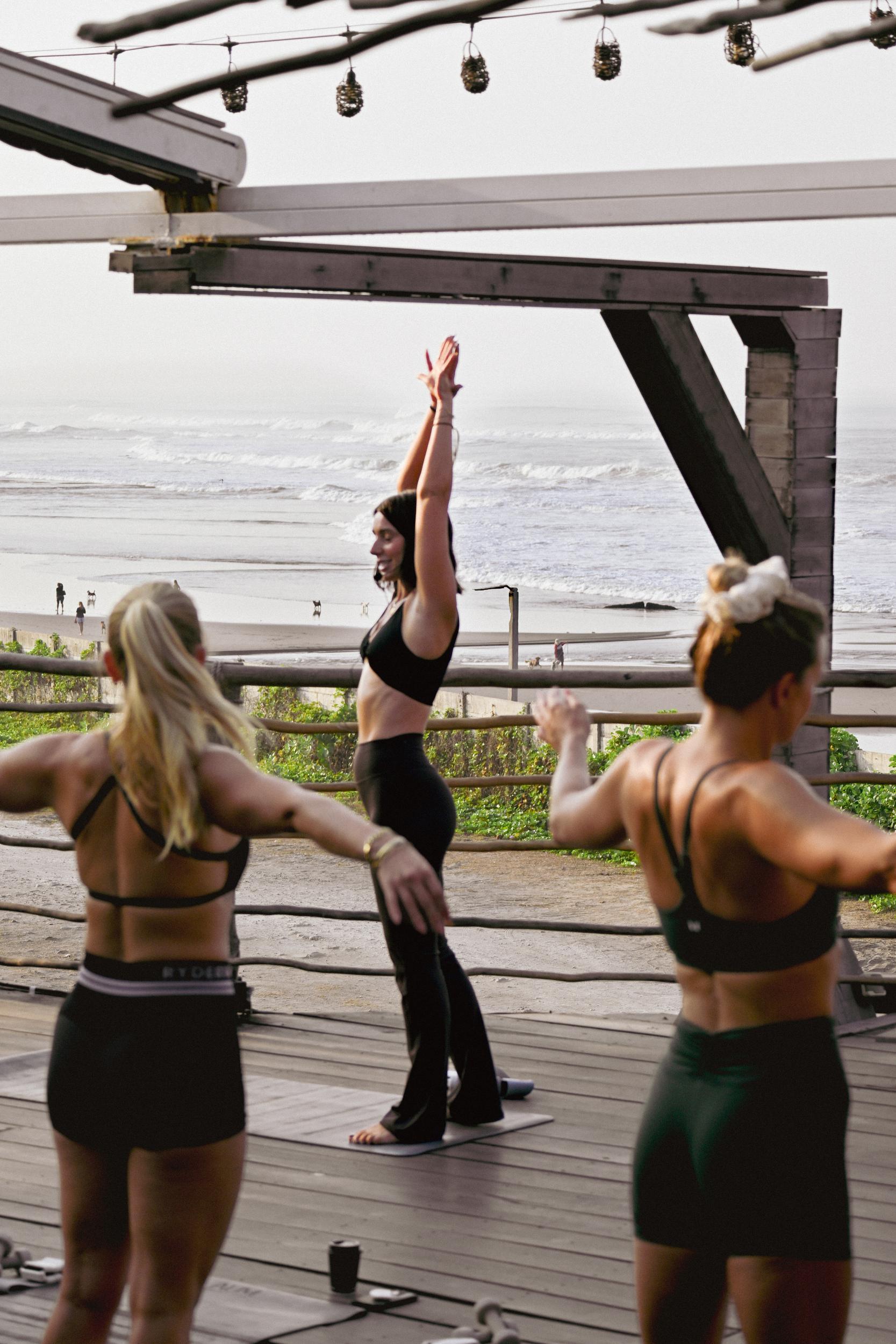 Becks leading a class on a rooftop above the ocean